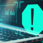 A large glowing warning sign with an exclamation mark floating in front of an open laptop.